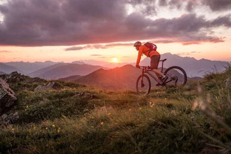 Man enjoying exceptional sunset views while hitting the best Missoula Mountain biking trails